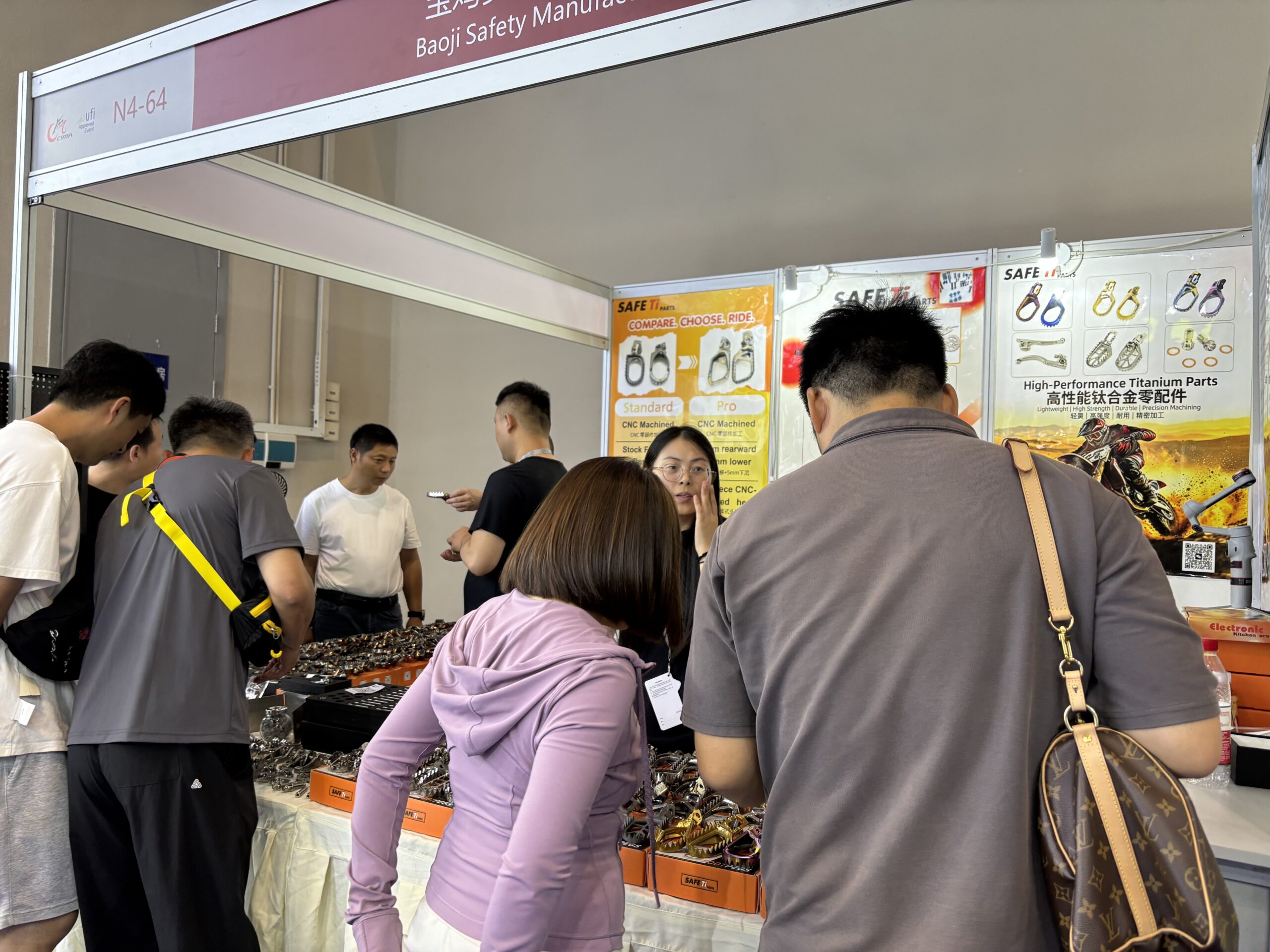 Visitors viewing motorcycle parts with the SAFETi team